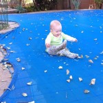 Bouncing and kicking on the pool cover.
