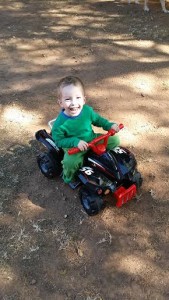 three year old on toy quad bike