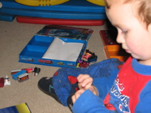 child playing with busy book figurines