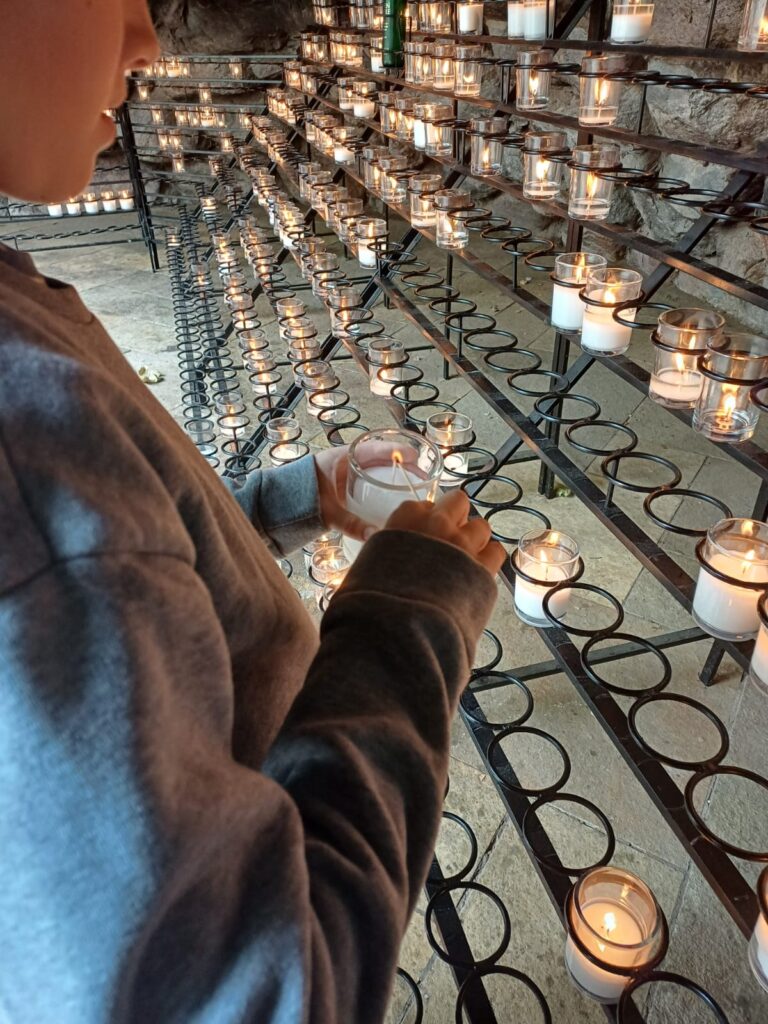 lighting a candle for my late husband at Notre Dame